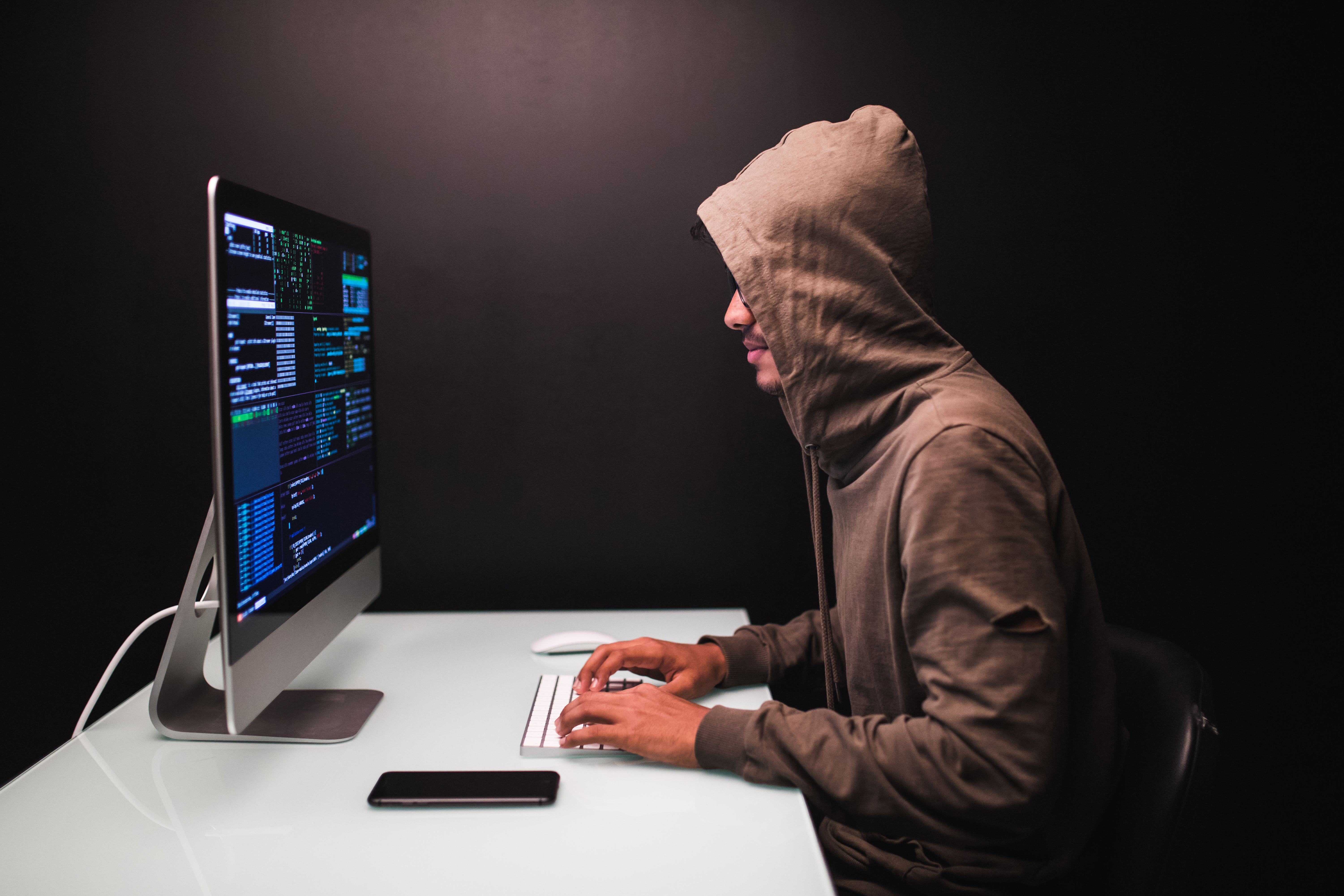 young-male-hacker-dark-room-writing-code-using-computer-virus-program-cyber-attack