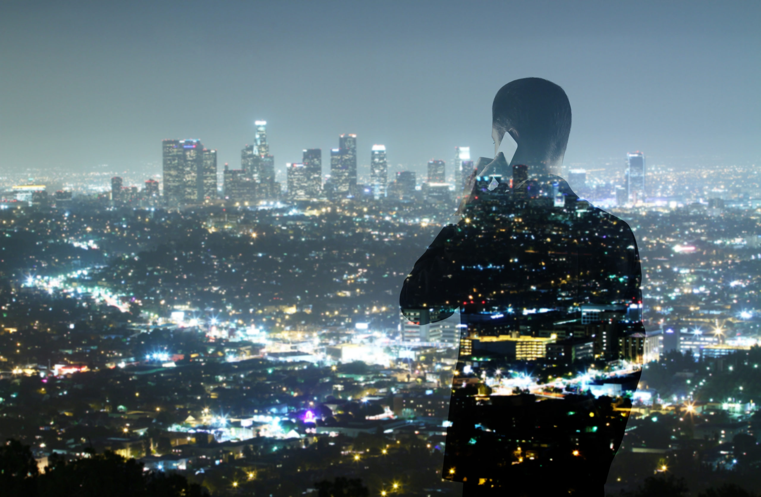 Figure-on-the-phone-infront-of-cityscape-scaled